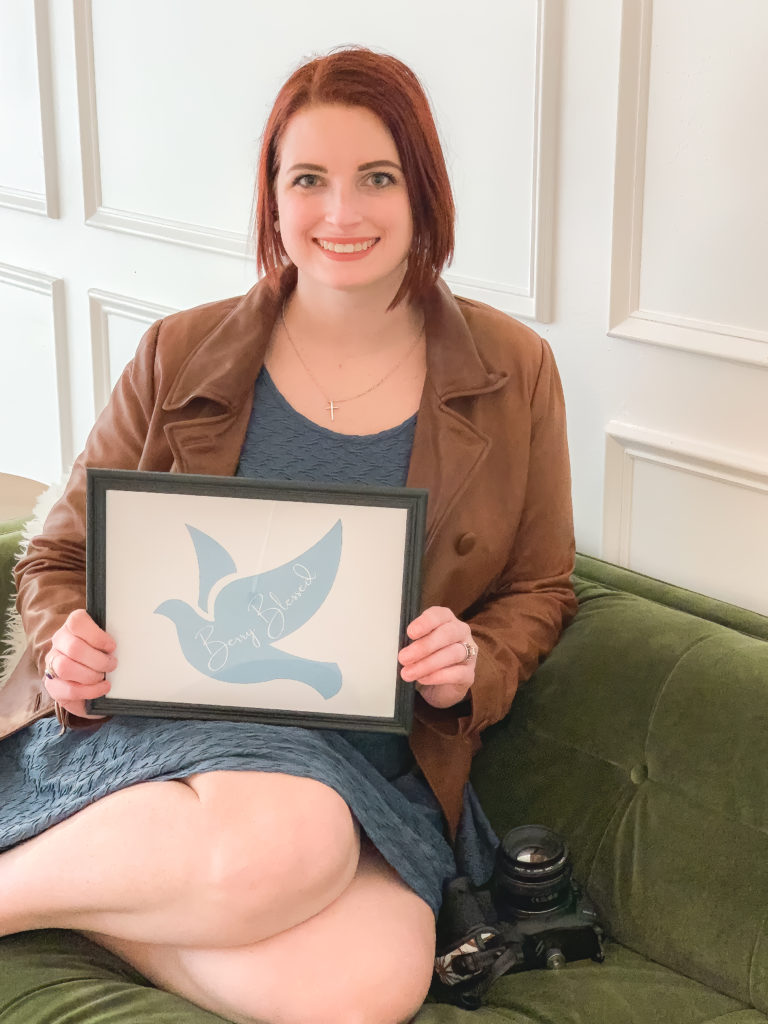 Dallas Family Photographer, Kimberlyn, holding a picture of logo
